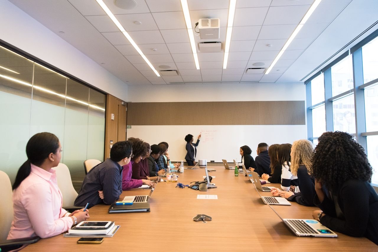Team watching a presentation at a long conference room table