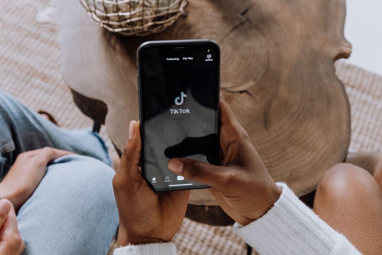 Smartphone with social media notification bubbles floating above the screen