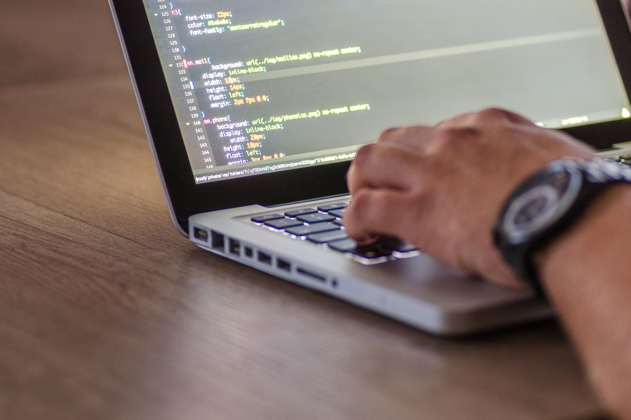 Person reviewing website performance metrics on a laptop screen at a desk